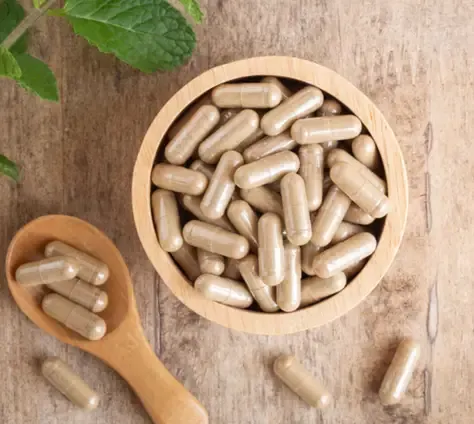 Capsules in a wooden bowl as a general supplement illustration